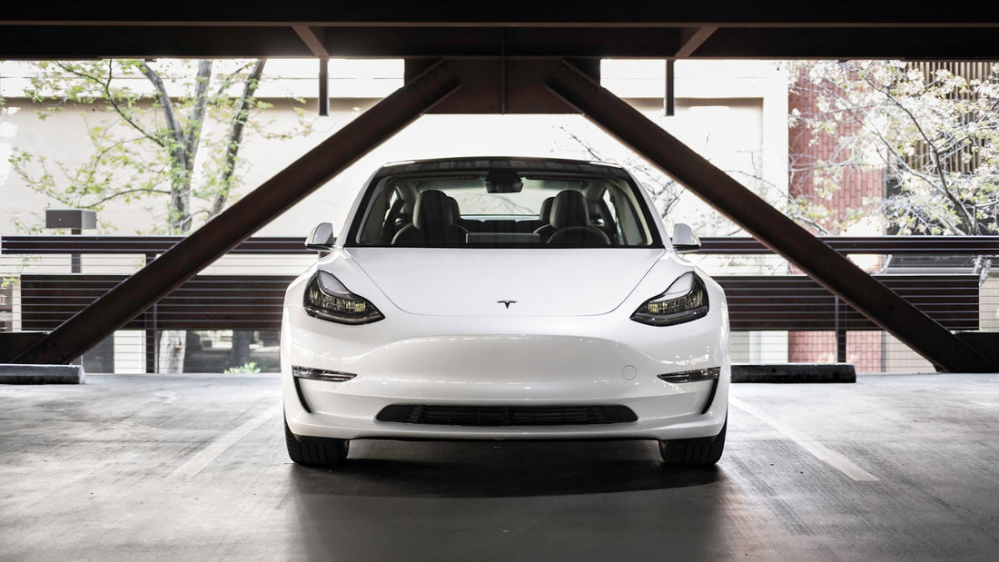 White Tesla in a parking structure