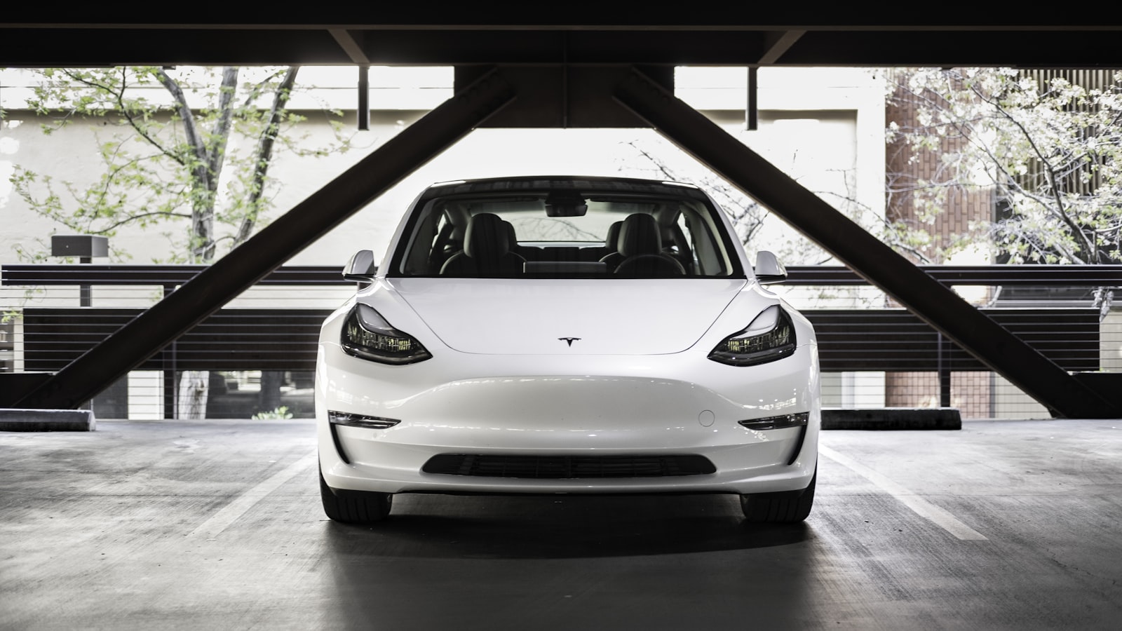 White Tesla in a parking structure