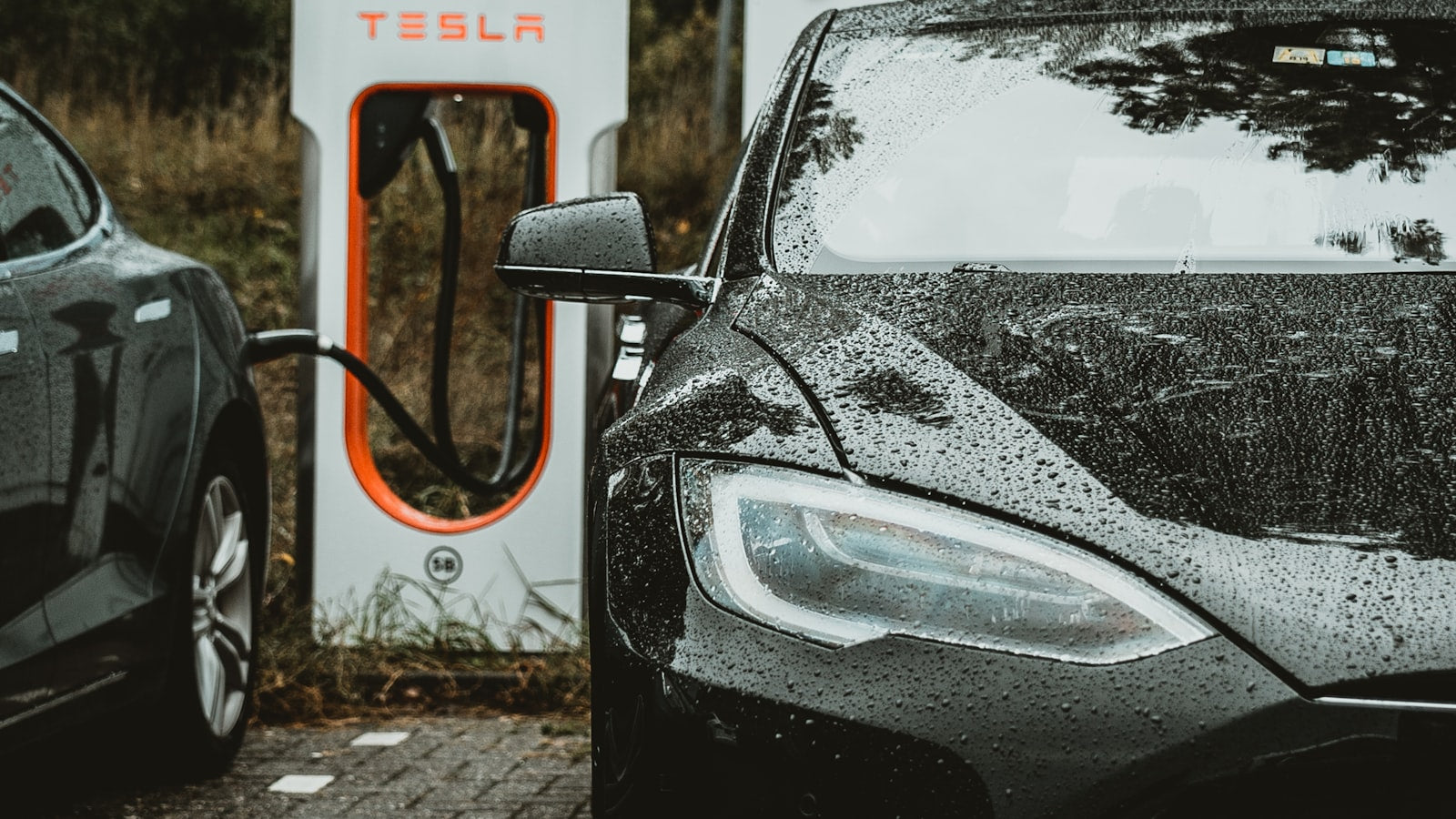 Tesla at a charging station at dusk