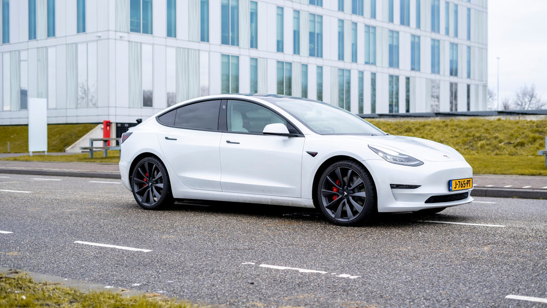 White Tesla Model 3 on the road