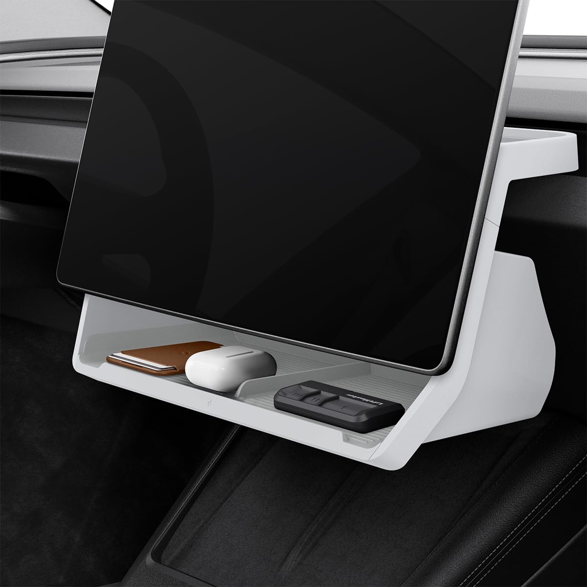 Spigen under-screen storage tray holding keys behind Tesla touchscreen