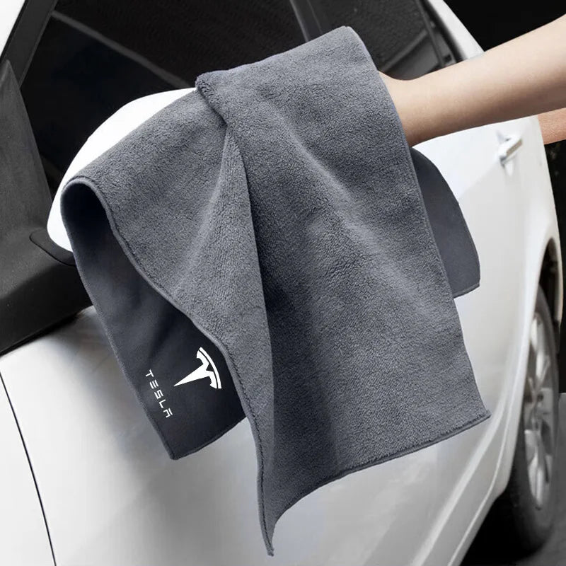 Microfiber towel wiping the side of a white car