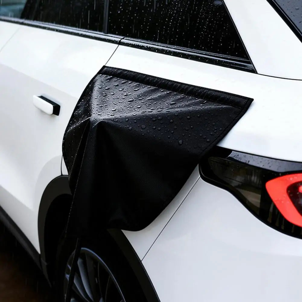 Rain beading off the waterproof EV charge port cover on a parked car