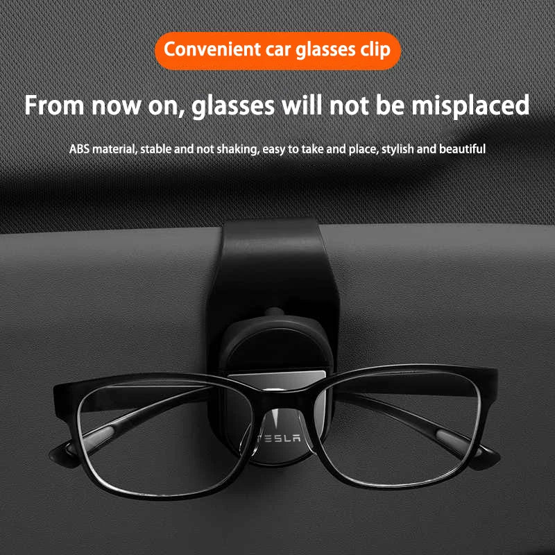 Tesla sunglasses clip holding glasses on a car sun visor