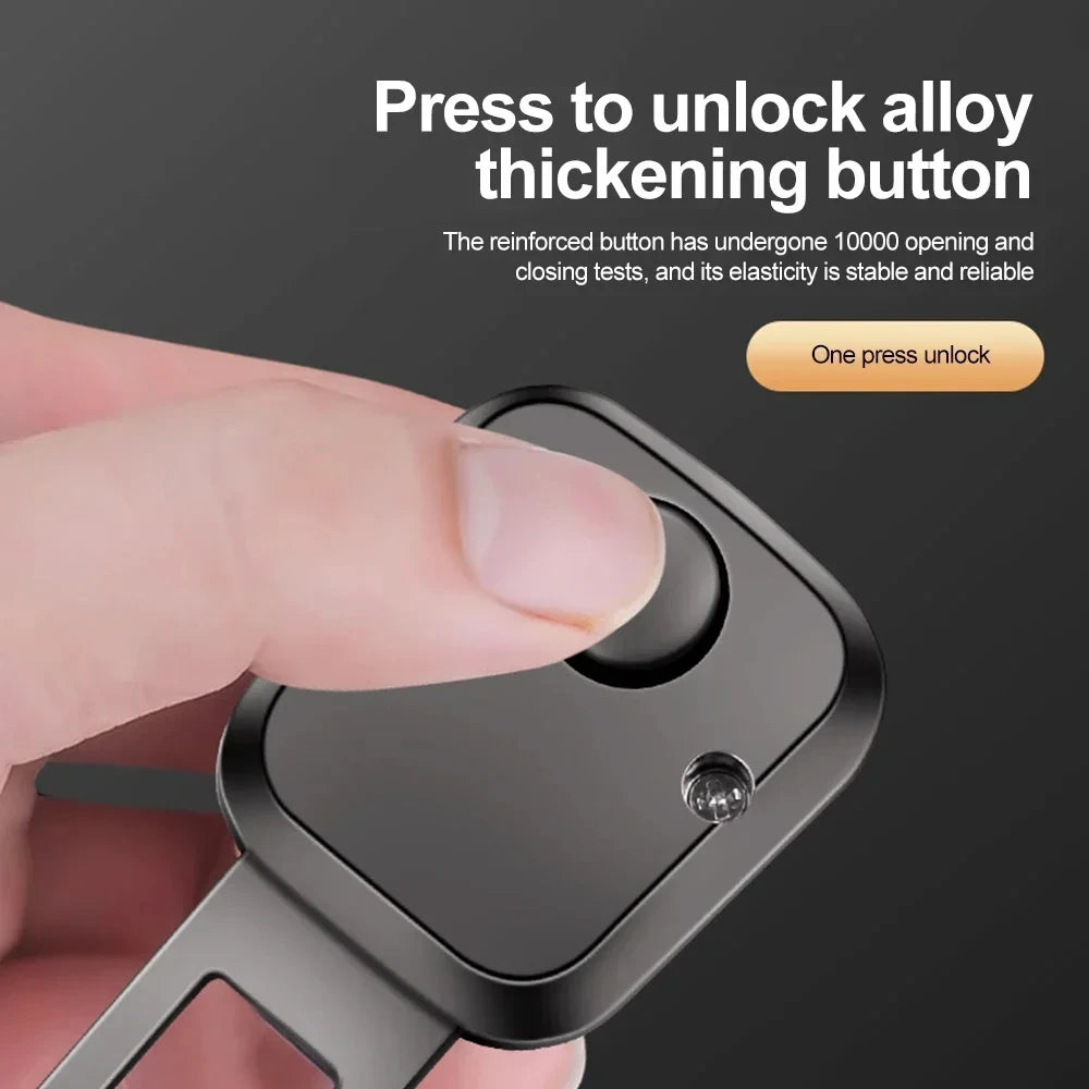 Thumb pressing the alloy release button on seat belt extender