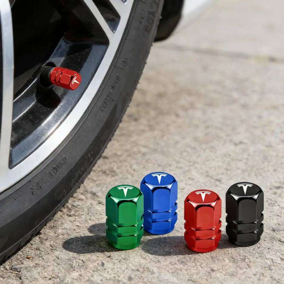 Red metal Tesla valve stem cap installed on a tire wheel