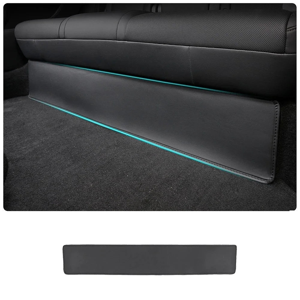 Tesla Model Y rear seat kick pad guard installed along lower seat back with ambient light