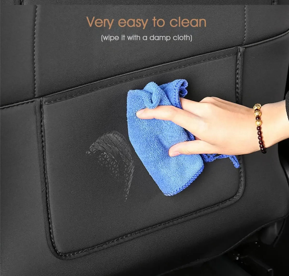 Wiping the Tesla seat back protector clean with a damp cloth