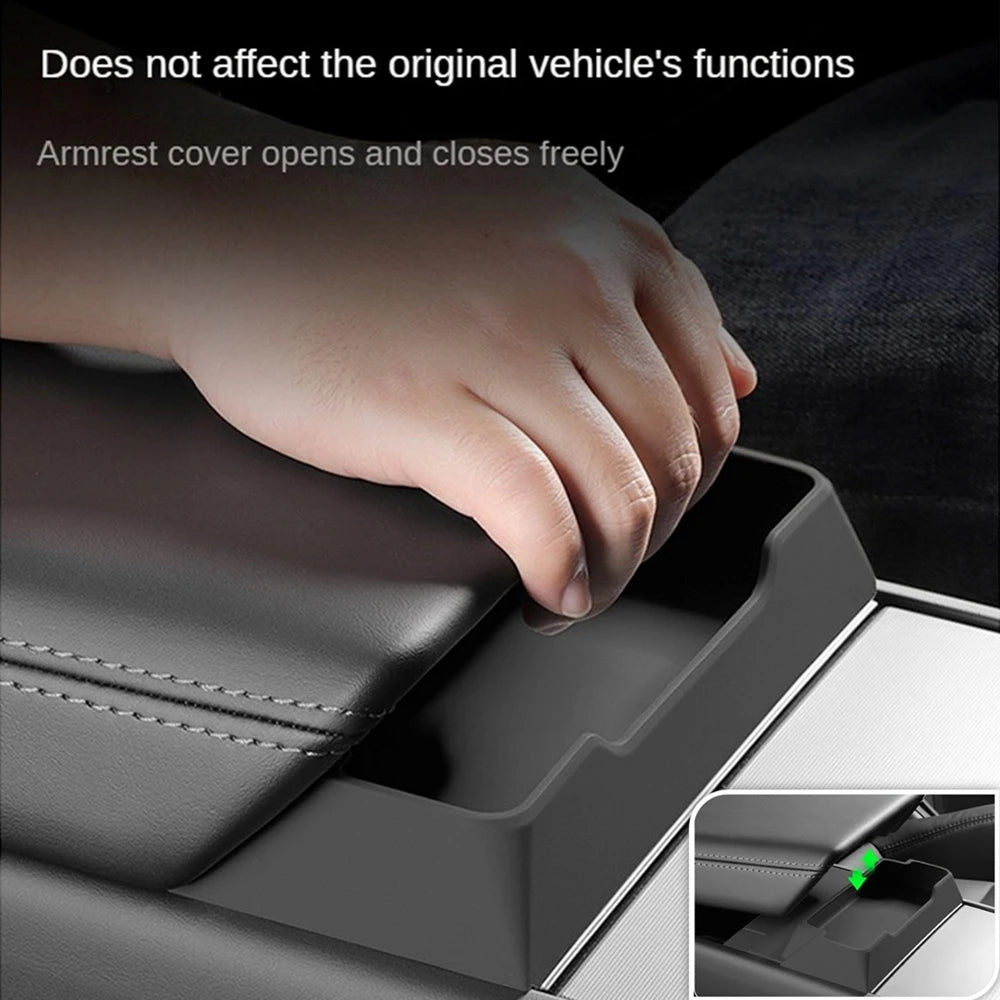 Hand using Tesla armrest glasses tray while the original armrest lid opens