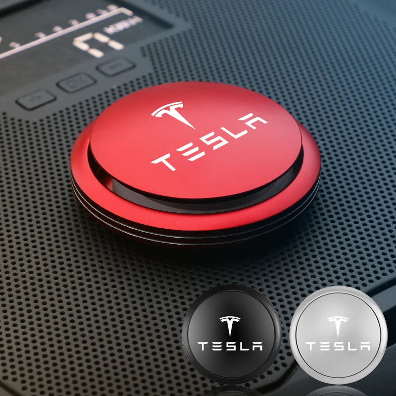 Red Tesla alloy air freshener mounted on car dash