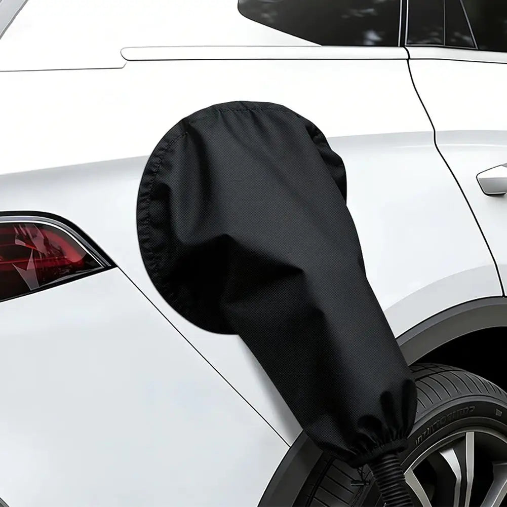 Black magnetic EV charge port cover installed over a connector on a white car