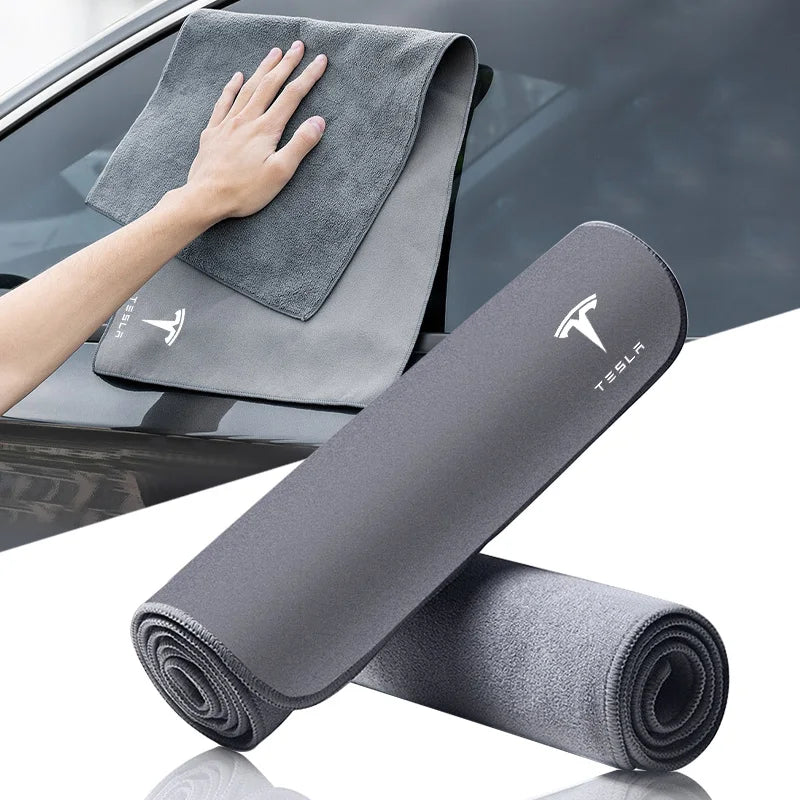 Grey microfiber car towel with Tesla logo rolled and laid flat