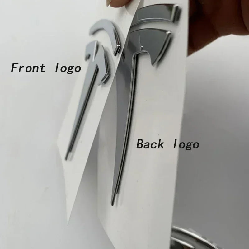 Front and rear Tesla T emblem badges shown on vehicle