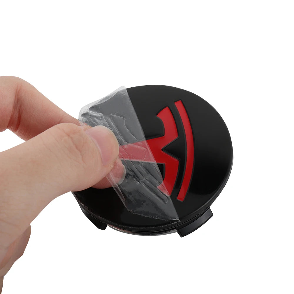 Adhesive backing peel-and-press install of the Tesla wheel center cap