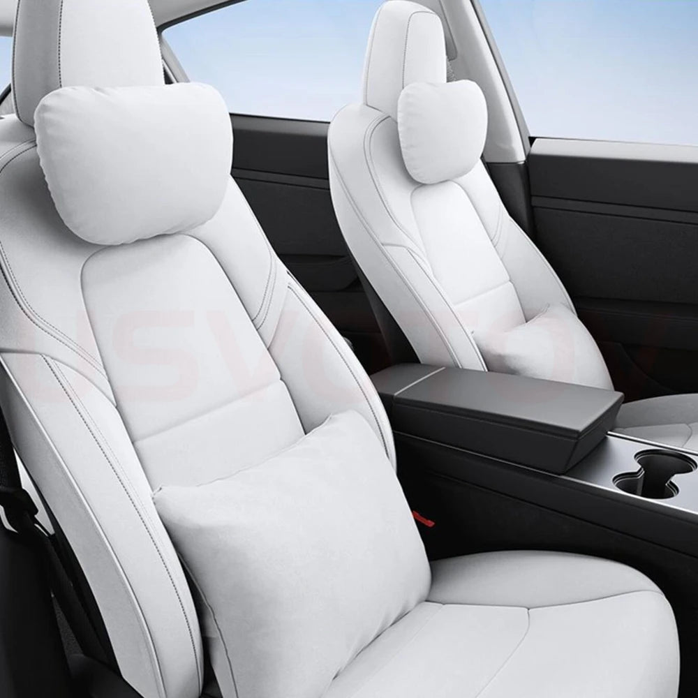 White headrest neck pillows on Tesla front seats interior view
