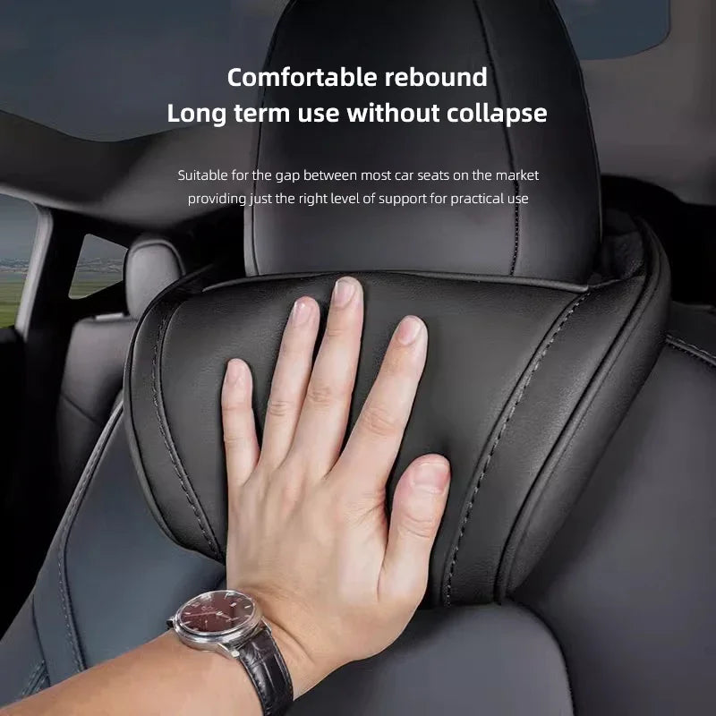 Hand pressing Tesla memory foam headrest pillow showing comfortable rebound