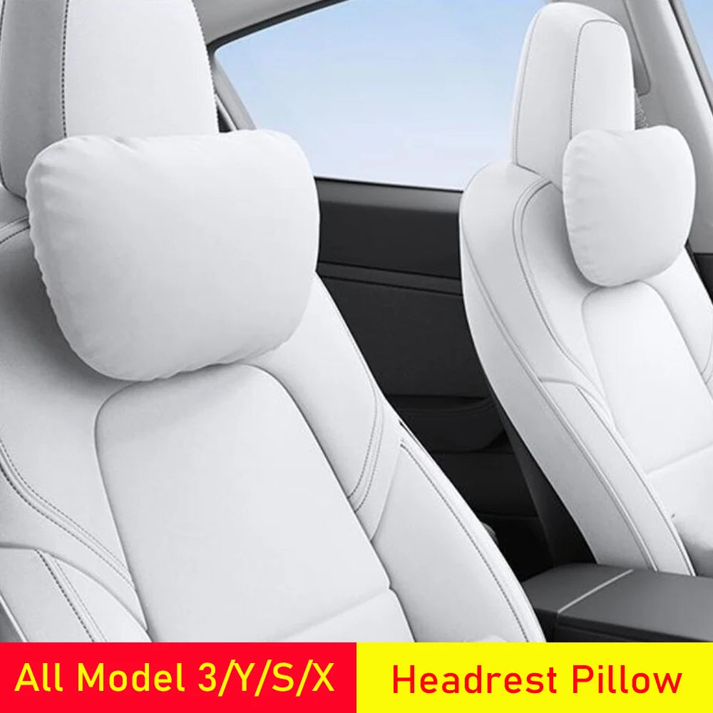 White Tesla headrest neck pillows mounted on Model 3 front seats