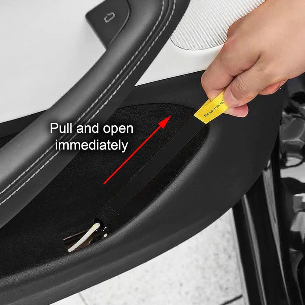 Tesla rear door emergency pull strap installed on door sill, hand pulling yellow release tab