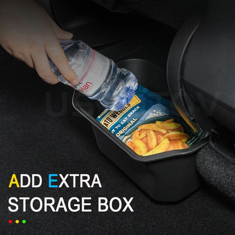 Hand placing snacks and a water bottle into Tesla Model Y rear storage box