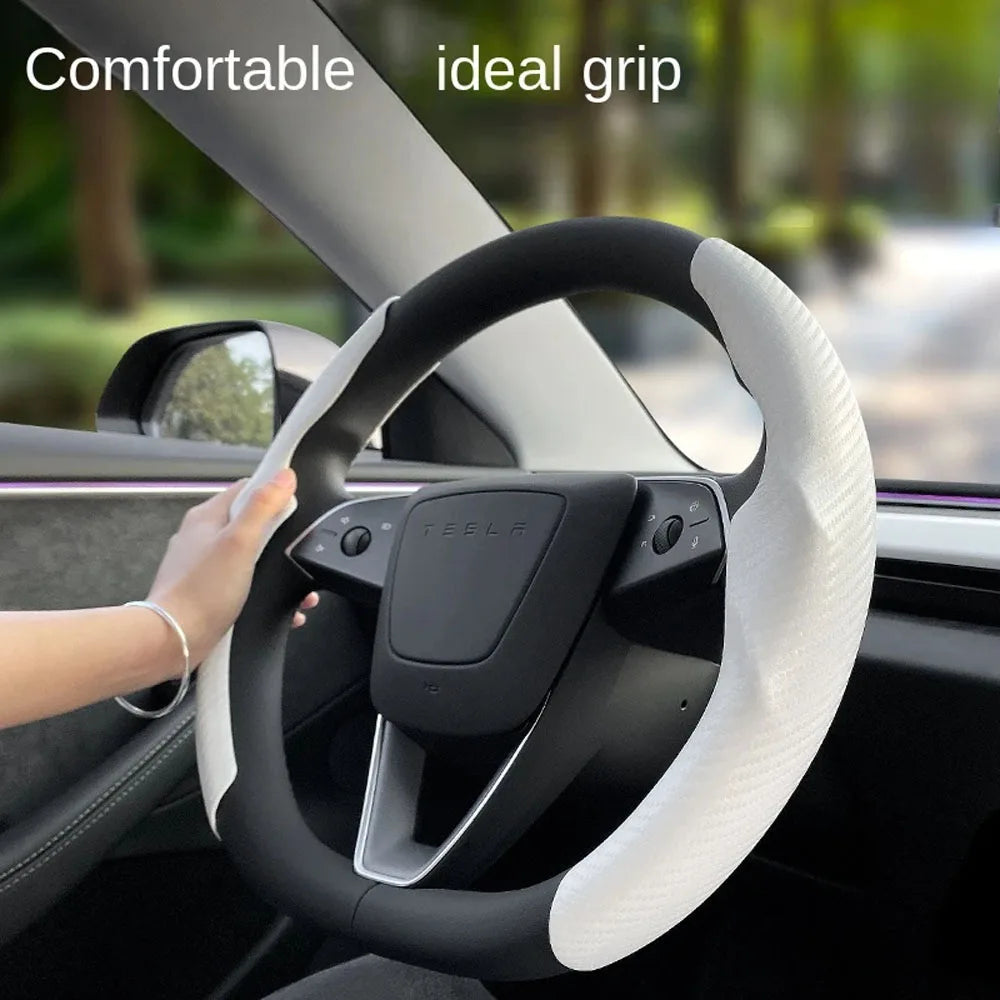 Hand gripping Tesla steering wheel cover showing comfortable grip