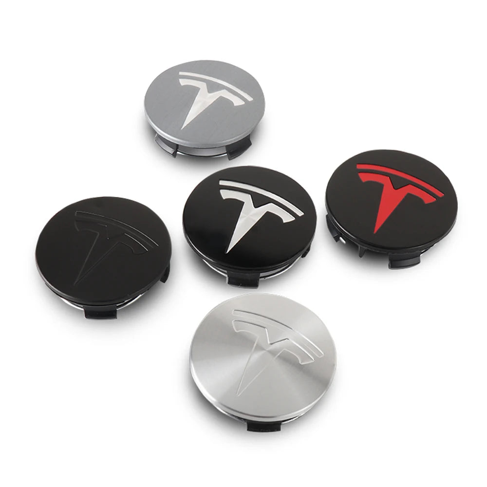 Tesla wheel center caps shown in silver, black, and brushed finishes