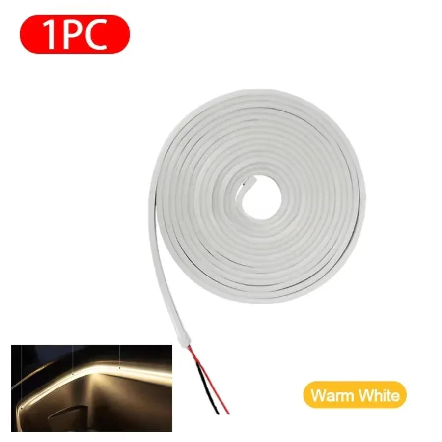 Warm white LED strip light, flexible design with red and black wires, ideal for ambient lighting